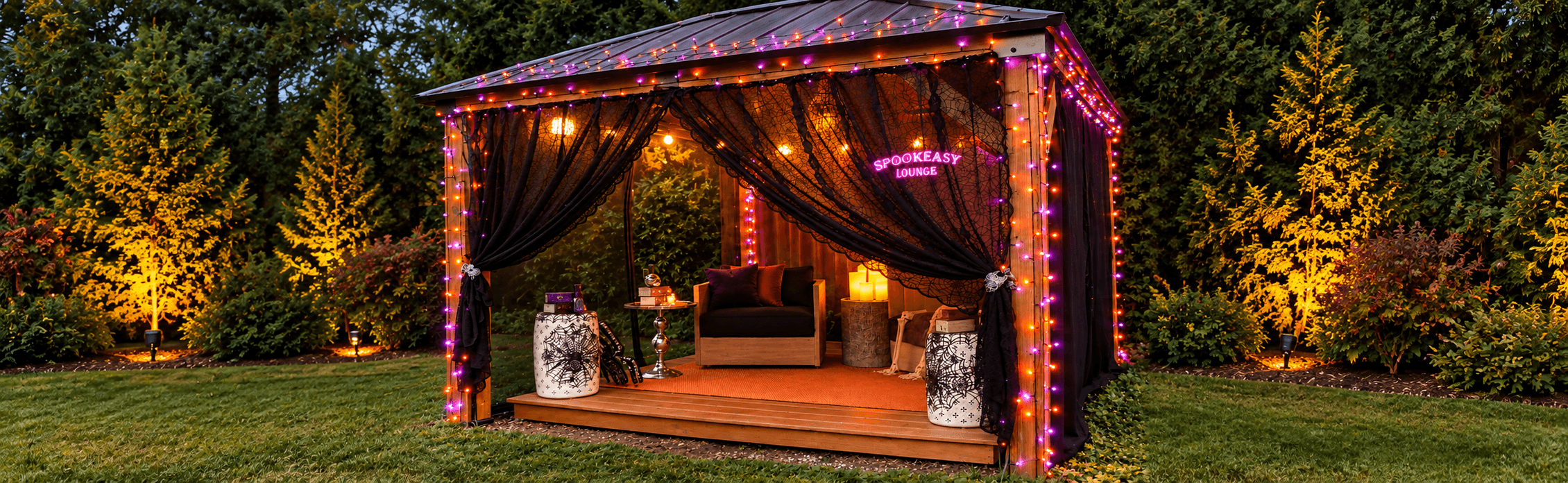 Outdoor Halloween gazebo decorated with black spiderweb curtains, purple and orange string lights, and a glowing Spookeasy Lounge sign.